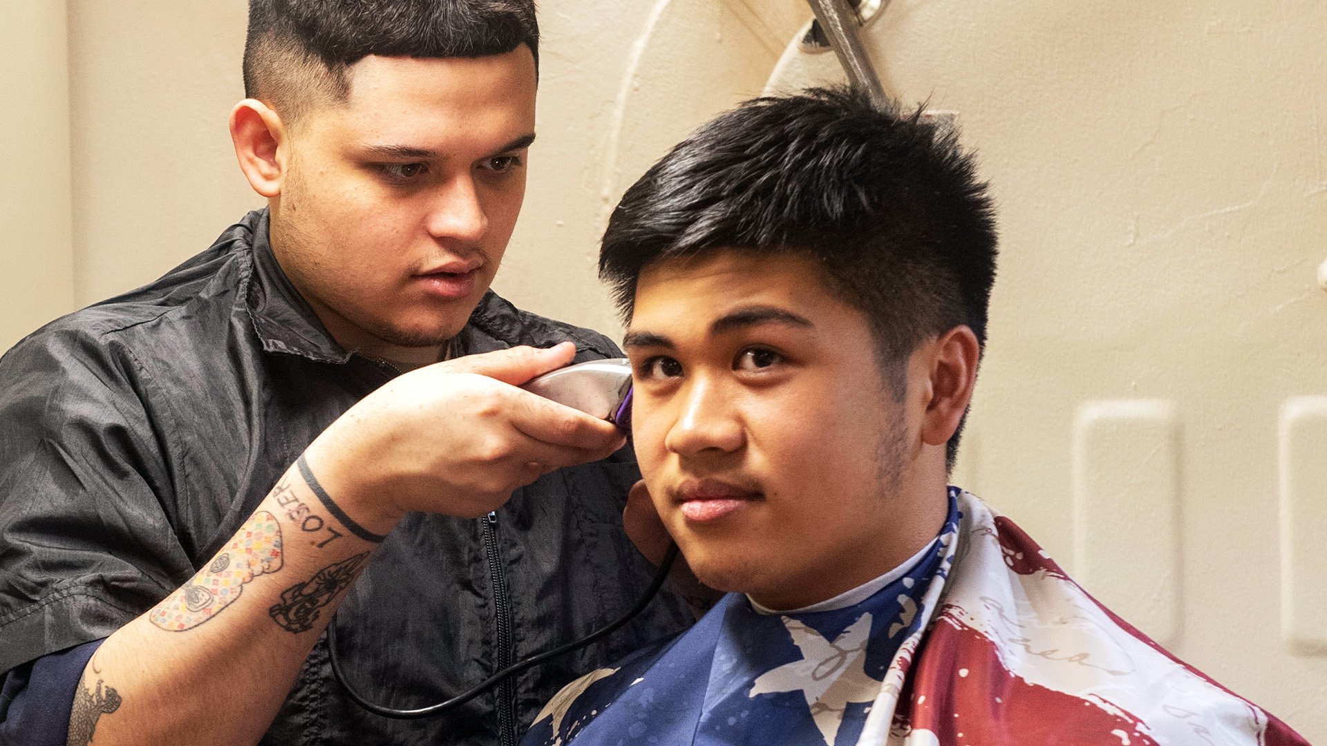 Retail Specialist Seaman Mario Arzate, provides a haircut to Logistics Specialist Seaman Marc Fiesta in the barber shop aboard the guided-missile destroyer USS Carney (DDG 64), Feb. 7, 2020. Carney is deployed to the U.S. 5th Fleet area of operations in support of naval operations to ensure maritime stability and security in the Central Region, connecting the Mediterranean and Pacific through the Western Indian Ocean and three strategic choke points. (U.S. Navy photo by Mass Communication Specialist 1st Class Fred Gray IV)