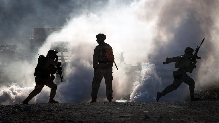 U.S. Marines with Echo Company, 2nd Battalion, 1st Marine Regiment, 1st Marine Division, maneuver to a building during a platoon-level urban assault as part of Service Level Training 4-26 at Marine Corps Air-Ground Combat Center Twentynine Palms, California, Aug. 30, 2026. SLTE is designed to be a challenging, realistic training exercise that produces combat-ready forces capable of operating as an integrated Marine Air-Ground Task Force across all domains of military operations. (U.S. Marine Corps photo by Lance Cpl. Journey Fisher)