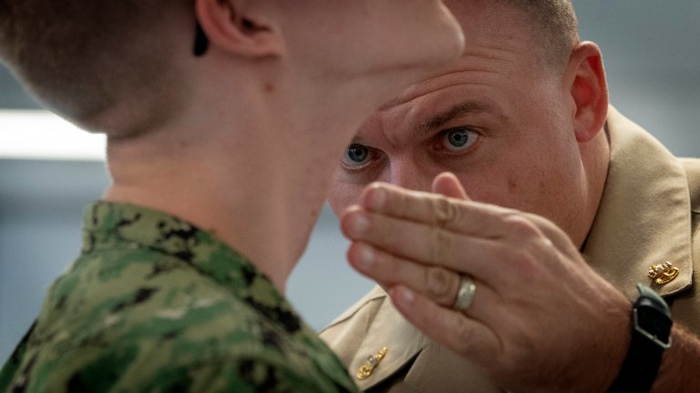 180910-N-PL946-1100 GREAT LAKES, Ill. (Sept. 10, 2018) Chief Operations Specialist James Conyne, a recruit division commander, inspects the quality of a recruit's shave before a personnel inspection inside a compartment in the USS Kearsarge barracks at Recruit Training Command (RTC). More than 30,000 recruits graduate annually from the Navy's only boot camp. (U.S. Navy photo by Mass Communication Specialist 2nd Class Spencer Fling)