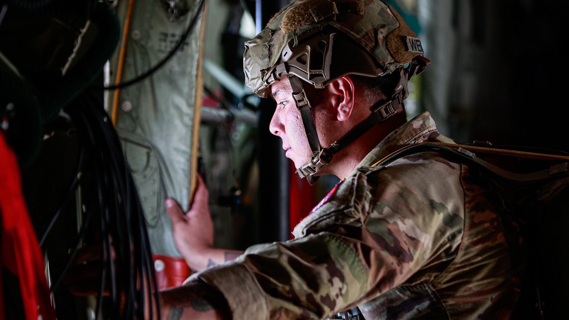 A U.S. Army Soldier belonging to the 82nd Airborne Division looks out the window of a Lockheed Martin C-130H before conducting cross static line jumps for Falcon Leap 24 at Eindhoven Airport, Eindhoven, Netherlands, on September 19, 2024. Falcon Leap 24 (FALE 24) is a Royal Dutch Military led, multinational, joint technical airborne exercise designed to enhance interoperability of participating NATO airborne forces and aircrews in personnel and equipment parachuting operations in Arnhem, Netherlands from 9-20 September 2024. Falcon Leap is NATO's largest technical airborne exercise which will also include ceremonies commemorating the 80th anniversary of Operation Market Garden. (U.S. Army photo by Spc. Samuel Signor)