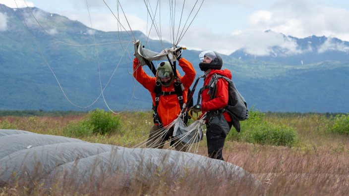 Alaska Air National Guard pararescuemen from the 212th Rescue Squadron conduct airborne operations from an Alaska Army National Guard CH-47F Chinook helicopter at Malemute Drop Zone, Joint Base Elmendorf-Richardson, Alaska, July 9, 2024. The Guardsmen of the 212th RQS and the 3rd Air Support Operations Squadron Tactical Air Control Party special warfare Airmen conducted joint airborne training to maintain the pararescue jumpers' proficiency in conducting full-spectrum personnel recovery to include both conventional and unconventional rescue operations and the TACPs to direct lethal and nonlethal joint firepower whenever necessary.
