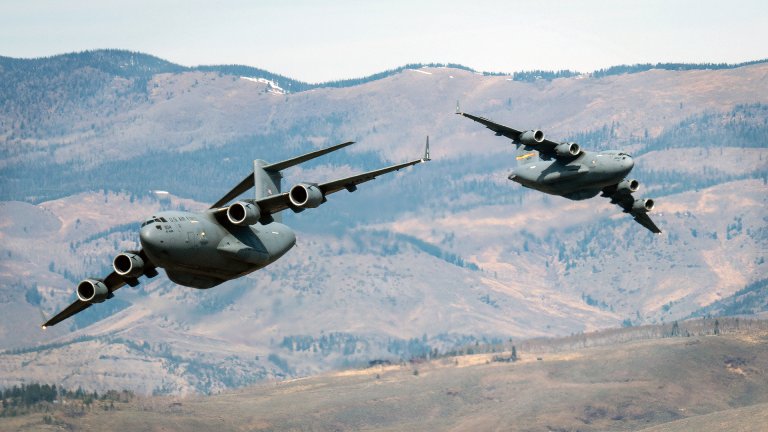 Two U.S. Air Force C-17 Globemaster III aircraft assigned to the 58th Airlift Squadron perform a weave maneuver over the central United States, March 27, 2026. The aircraft were part of a three-ship formation flown to commemorate the 30th anniversary of the C-17’s arrival at Altus Air Force Base, Oklahoma. (U.S. Air Force photo by Airman 1st Class Nathan Langston)