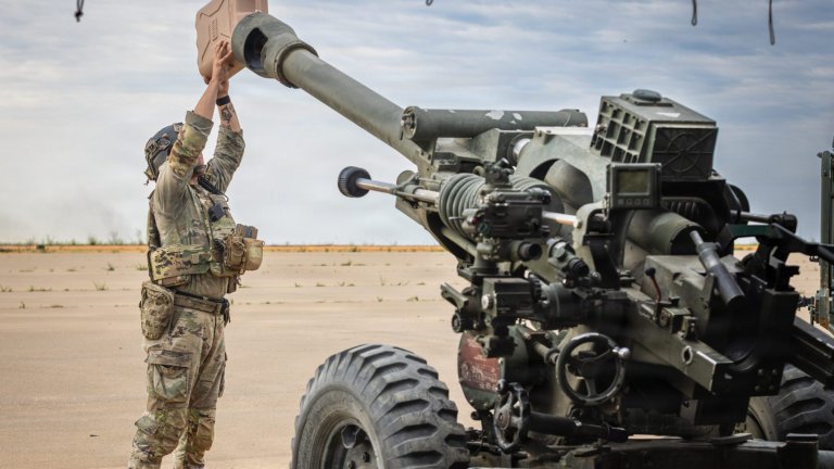 An Explosive ordnance disposal technician with the 192nd Ordnance Battalion (EOD), 52nd Ordnance Group (EOD), pours mineral water into an M777 155 mm howitzer to eject a stuck round during an EOD capabilities exercise at Fort Bragg, N.C., May 6, 2026. The 52nd Ordnance Group (EOD) is one of two EOD groups that serve under the 20th Chemical, Biological, Radiological, Nuclear, Explosives (CBRNE) Command, which is home to 75% of the active-duty U.S. Army EOD technicians. (U.S. Army photo by Pfc. Alexis Fischer)