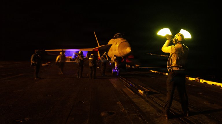 A U.S. Sailor signals an F/A-18E Super Hornet, attached to Strike Fighter Squadron (VFA) 131, on the flight deck of Nimitz-class aircraft carrier USS George H.W. Bush (CVN 77) while sailing in the Arabian Sea, June 25, 2026. USS George H.W. Bush is deployed to the U.S. 5th Fleet area of operations to support maritime security and stability in the Middle East. (U.S. Navy photo) 