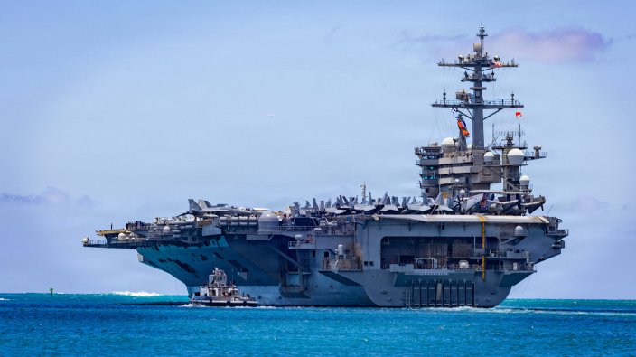Nimitz-class aircraft carrier USS Theodore Roosevelt (CVN 71) departs Joint Base Pearl Harbor-Hickam, Hawaii, during Exercise Rim of the Pacific 2026, July 7, 2026. Thirty nations, over 30 surface ships, five submarines, 15 national land forces, more than 206 aircraft and 30,000 personnel are participating in RIMPAC in and around the Hawaiian Islands, June 24 to July 31. The world's largest international maritime exercise, RIMPAC provides a unique training opportunity while fostering and sustaining cooperative relationships among participants critical to ensuring the safety of sea lanes and security on the world's oceans. RIMPAC 2026 is the 30th exercise in the series that began in 1971. (U.S. Navy photo by Mass Communications Specialist First Class Luke McCall)