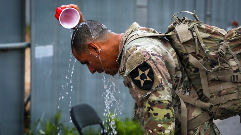 U.S. Army Sgt. Chris Sebastian Morales, a human resources specialist assigned to the 19th Human Resources Company, Division Sustainment Troops Battalion, 2d Infantry Division Sustainment Brigade, pours water over his head to cool down during a water break while conducting the Adjutant General Service member of the year Ruck March at Camp Humphreys, South Korea, July 16, 2026. Sustaining administrative excellence and personnel readiness demonstrates the critical role of human resources in military lethality, showcasing the division’s ability to seamlessly synchronize U.S. and ROK manpower to maintain combat power and reinforce the strength of the ROK–U.S. Alliance. (U.S. Army photo by KCpl Yoon Hyeok Choi)