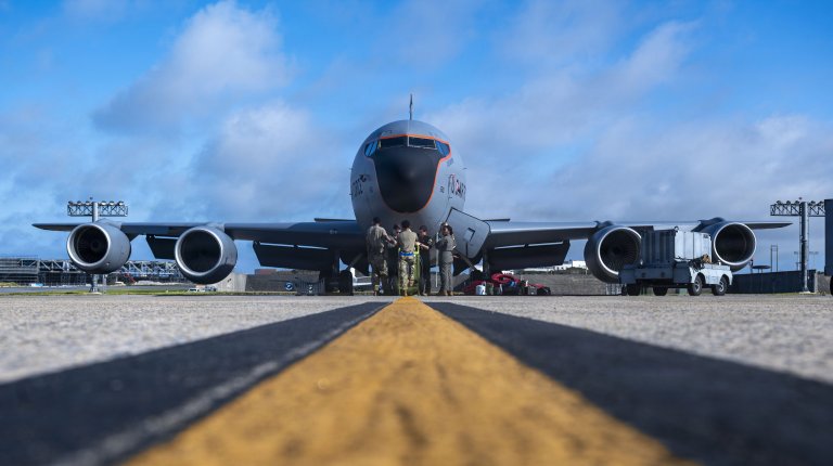 U.S. Air Force Airmen assigned to the 909th Air Refueling Squadron and 718th Aircraft Maintenance Squadron, participate in a preflight brief in front of a KC-135 Stratotanker assigned to the 909th ARS at Kadena Air Base, Japan, July 15, 2026. The 909th ARS provides air refueling to joint U.S., joint and allied aircraft throughout the Pacific region. (U.S. Air Force photo by Airman 1st Class Gracelyn Hess)