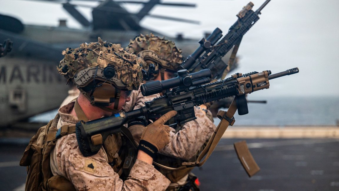 U.S. Marines with Lima Company, Battalion Landing Team 3/5, 11th Marine Expeditionary Unit, reload their M27 infantry automatic rifles during a live-fire range on the flight deck of San Antonio-class amphibious transport dock USS Portland (LPD 27) in the U.S. Central Command area of responsibility, August 31, 2026. (U.S. Marine Corps photo by Cpl. Avery Wayland) 