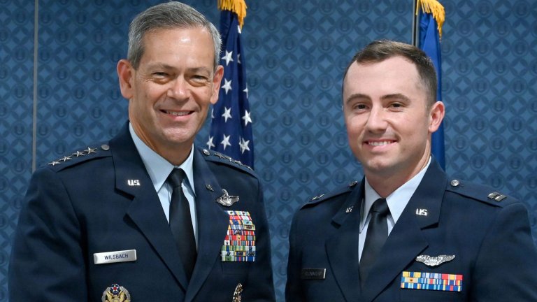 Air Force Chief of Staff Gen. Ken Wilsbach, left, presents an award citation to Capt. Michael Cloninger, right, F-22 Raptor pilot from the 90th Fighter Squadron, 3rd Operations Group, Joint Base Elmendorf-Richardson, Alaska, during a ceremony at the Pentagon, Sept. 8, 2026. Cloninger was presented with the 2025 Koren Kolligian, Jr. Trophy, which recognizes outstanding feats of airmanship by aircrew members who by extraordinary skill, exceptional alertness, ingenuity, or proficiency, averted accidents or minimized the seriousness of the accidents in terms of injury, loss of life, aircraft damage, or property damage. (U.S. Air Force photo by Chad Trujillo) 