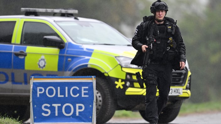 Header: WHELFORD, ENGLAND - SEPTEMBER 27: Armed police maintain road blocks and security checks around RAF Fairford on September 27, 2026 in Fairford, England. Police have declared a major incident after evacuating residents from their homes in Whelford, a village about one mile from RAF Fairford, a military base that hosts U.S. Air Force bombers involved in the Iran conflict. Several men have been arrested on suspicion of offences under the explosives act, and the Army's specialist explosive ordnance disposal team are examining a number of vehicles in the area. (Photo by Leon Neal/Getty Images)