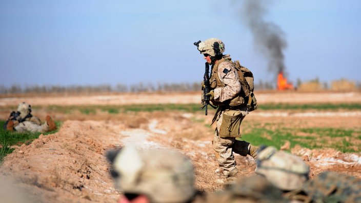 Marines from the first Battalion, 6th regiment run for cover after hearing bullets whizzing during a patrol in the outskirts of Marjah in central Helmand on 19 January, 2010.The crisp crackling of AK-47s breaks the morning silence as US Marines inch towards the outskirts of a Taliban stronghold in Afghanistan's southern province of Helmand.The Marines are on one of the patrol missions to inch closer to Marjah in Helmand province, which produces the bulk of the world's opium poppy, the main ingredient in the production of heroin.AFP PHOTO/CHRISTOPHE SIMON (Photo credit should read CHRISTOPHE SIMON/AFP via Getty Images)