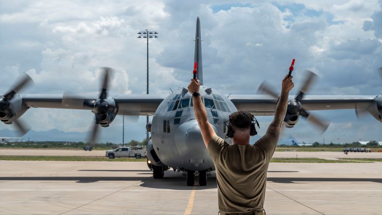 A U.S. Airman assigned to the 55th Electronic Combat Group marshals an EC-130H Compass Call aircraft assigned to the 55 ECG after its final flight at Davis-Monthan Air Force Base, Arizona, Sept. 2, 2026. Over the last 20 years alone, EC-130H crews have flown over 76,000 combat hours in support of various named operations worldwide.