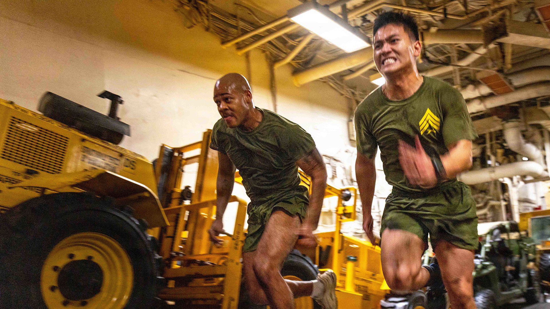 Marines race up a ramp during a noncommissioned officer physical training event aboard the amphibious assault ship USS Boxer in the U.S. Central Command area of responsibility, Aug. 28, 2026.
