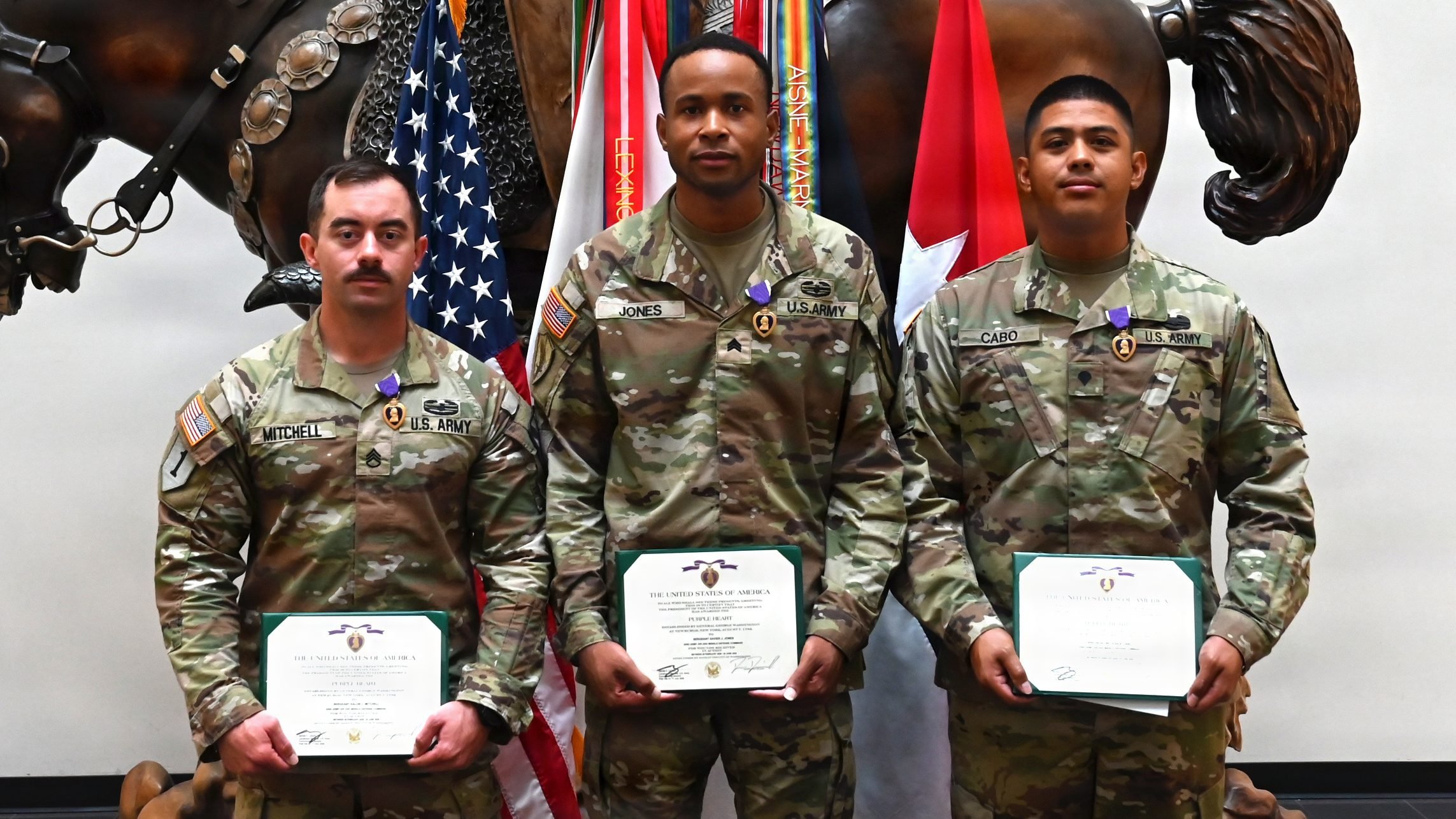 (from left to right) Staff Sgt. Kalob Mitchell, Sgt. Xavier Jones and Spc. Nicholas Cabo, all part of 6th Battalion, 56th Air Defense Artillery Regiment, 1st Cavalry Division Artillery, pose for a photo after receiving the Purple Heart during a recognition ceremony on Oct. 1 at the III Armored Corps headquarters building at Fort Hood, Texas. Mitchell, Jones and Cabo received the medal for saving two lives during an event with Operation Epic Fury. (U.S. Army photo by Derika Upshaw, Fort Hood Public Affairs)
