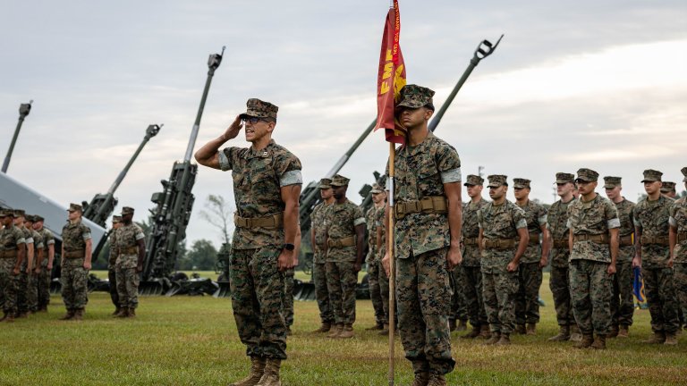 U.S. Marines with 1st Battalion, 10th Marine Regiment, 2nd Marine Division present arms during a re-designation ceremony at WPT Hill Field, Camp Lejeune, North Carolina, Oct. 9, 2026. The ceremony officially recognized the Battalion’s transition from an Artillery Battalion to a Medium Missile Battalion, improving 1st Battalion, 10th Marines’ capabilities to provide support to operations and exercises involving sea denial and littoral access, in line with Marine Corps Force Design. (U.S. Marine Corps photo by Sgt. Alexis French) 