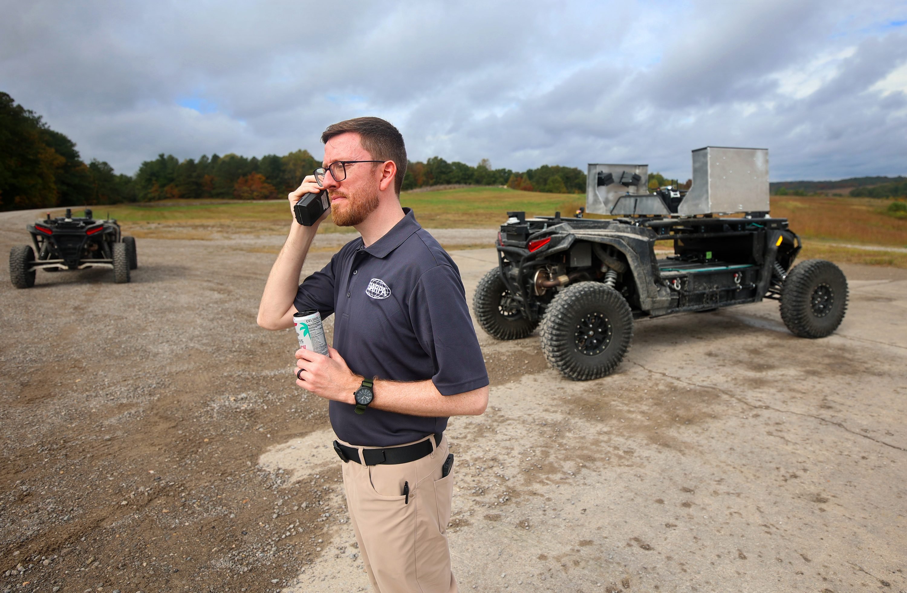 Dr. Jason Gregory, technical advisor at DARPA, works at the final details of a live fire exercise at Fort Knox, Kentucky, Oct. 15, 2026 featuring four autonomous unmanned ground vehicles that independently travel across St. Vith Range, hunting for enemy targets.
