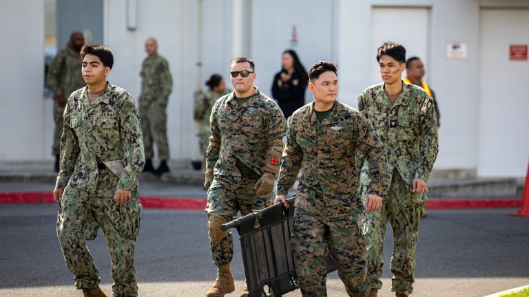 U.S. Navy Sailors assigned to Navy Medicine Readiness and Training Unit Iwakuni and 3rd Medical Battalion, Forward Resuscitative Surgical System carry equipment on a simulated casualty during Exercise Keen Sword 27 (KS27) at Marine Corps Air Station Iwakuni, Japan, Oct. 23, 2026. Keen Sword is a routine, biennial bilateral field training exercise with multinational participation, designed to increase readiness and interoperability between the U.S. military and Japan Self-Defense Forces while strengthening the ironclad U.S.-Japan Alliance. (U.S Marine Corps photo by Lance Cpl. Tahir Noel) 