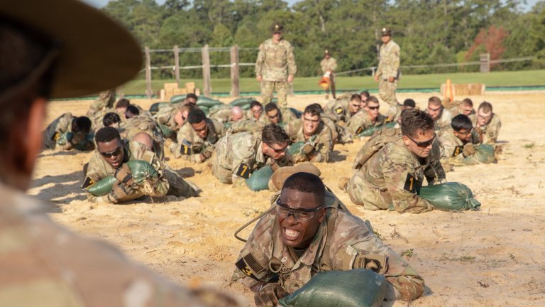 U.S. Army Sgt. Rameel Serrano, assigned to U.S. Western Hemisphere Command, low crawls ahead of fellow competitors in the First 100 Yards event during the 2026 U.S. Army Best Squad Competition, at Fort Benning, Georgia, Sept. 14, 2026. The Best Squad Competition showcases the discipline, training, and global reach that make our force the ultimate guarantor of the Nation's security. (U.S. Army photo by Spc. Jordan Bristol)