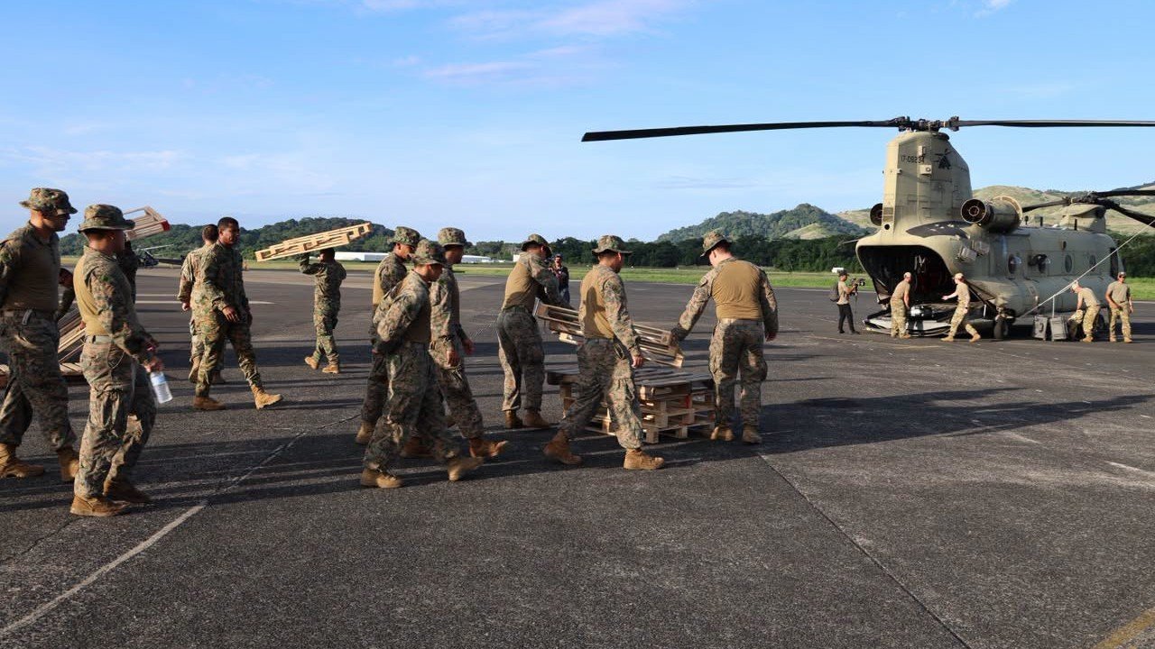 U.S. military personnel load up a helicopter to deliver supplies to Panama. U.S. Southern Command photo.