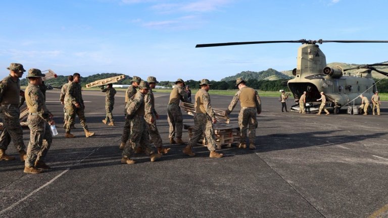 U.S. military personnel load up a helicopter to deliver supplies to Panama. U.S. Southern Command photo.