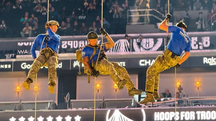 U.S. Air Force pararescuemen assigned with the 131st Rescue Squadron, 129th Rescue Wing, California Air National Guard perform a rappel demonstration to deliver the game ball at the Golden State Warriors' Hoops for Troops military appreciation game at Chase Center, San Francisco, Nov. 25, 2024. (U.S. Air National Guard video by Staff Sgt. Duane Ramos)