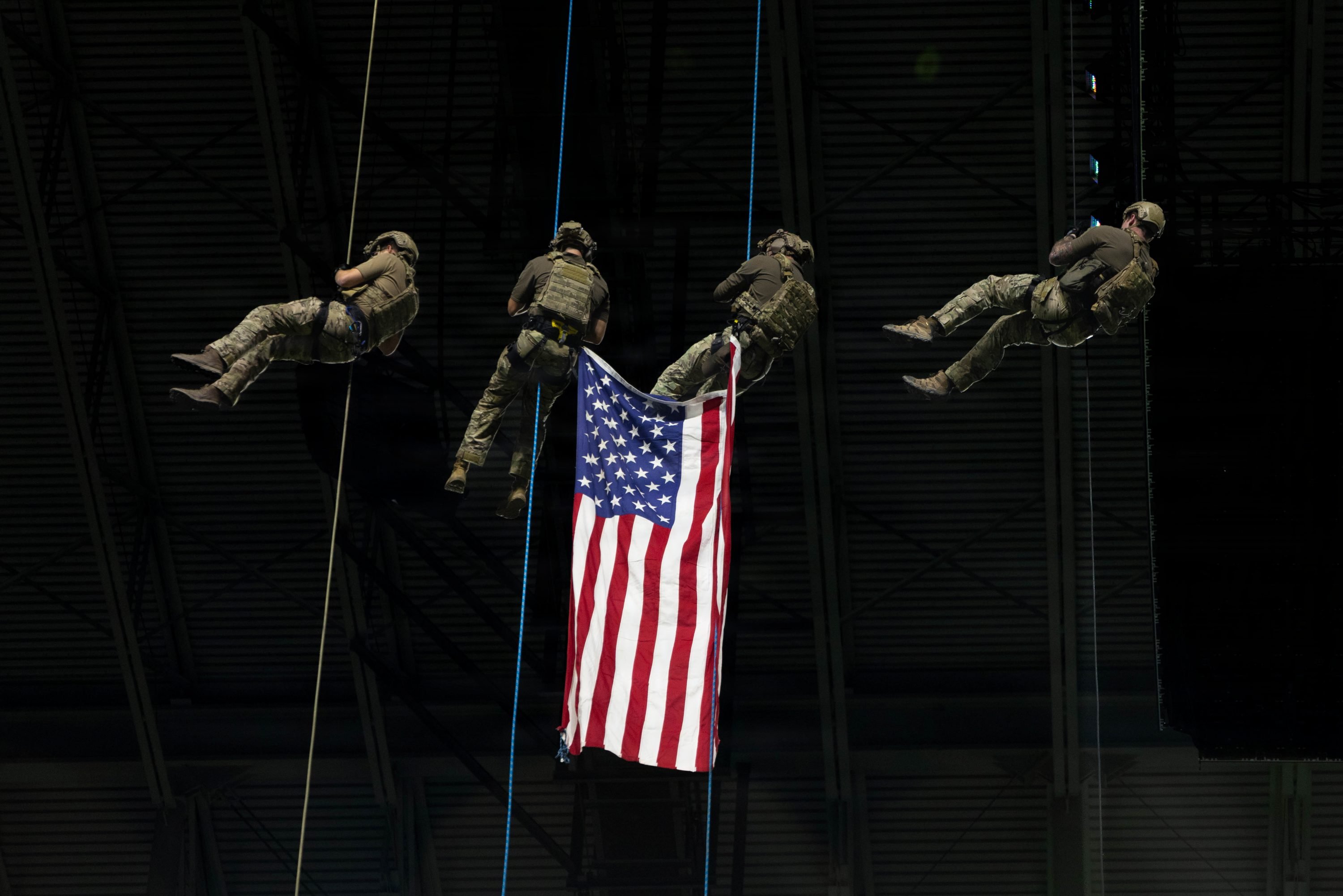 A group of U.S. Army Soldiers repel onto the field with an american flag for the national anthem during an American Conference football game between the Army West Point Black Knights and University of Texas San Antonio Roadrunners in the Alamodome, San Antonio, Texas, Nov. 29, 2025. Each game, the team honors a U.S. Army unit by wearing its insignia on their helmets. In 2025, the 1st Cavalry Division was chosen as the honored unit. (U.S. Army Photo By Spc. David Dumas)