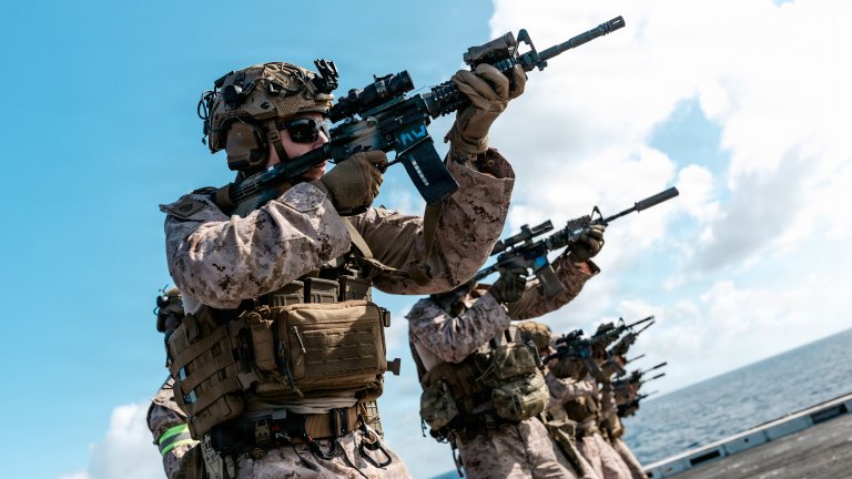 Featured Art: A U.S. Marine with Battalion Landing Team 3/5, 11th Marine Expeditionary Unit, fires an M4 carbine on the flight deck of San Antonio-class amphibious transport dock ship USS Portland (LPD 27) during marksmanship training in the Indian Ocean, June 25, 2026. The 11th MEU, embarked aboard the Boxer Amphibious Ready Group, is a persistent, combat credible force contributing to deterrence and crisis response in the U.S. 7th Fleet area of operations. U.S. 7th Fleet, the U.S. Navy’s largest forward-deployed numbered fleet, routinely interacts and operates with allies and partners to preserve a free and open Indo-Pacific. (U.S. Marine Corps photo by Lance Cpl. Luke Rodriguez) 