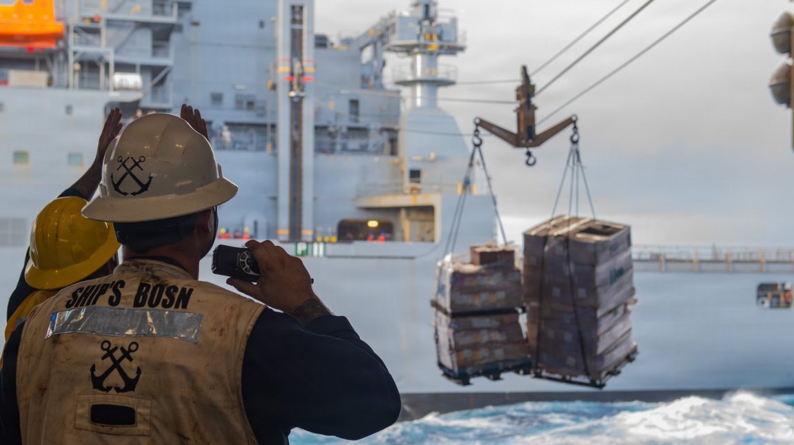 U.S. Navy Ensign Elias Dalton, assigned to the Nimitz-class aircraft carrier USS Theodore Roosevelt (CVN 71), supervises the transfer of supplies from the Lewis and Clark-class dry cargo ship USNS Washington-Chambers (T-AKE-11) during a replenishment-at-sea during Exercise Rim of the Pacific, July, 19, 2026. Thirty nations, 30 ships, five submarines, 15 national land forces, more than 190 aircraft and more than 30,000 personnel are participating in RIMPAC in and around the Hawaiian Islands, June 24 to July 31. The world's largest international maritime exercise, RIMPAC provides a unique training opportunity while fostering and sustaining cooperative relationships among participants critical to ensuring the safety of sea lanes and security on the world's oceans. RIMPAC 2026 is the 30th exercise in the series that began in 1971. (U.S. Navy photo by Mass Communication Specialist 3rd Class Alexia Mezick)