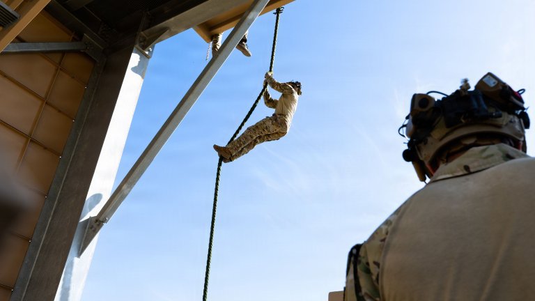 A U.S. tactical air control party airman assigned to Detachment 2, 6th Combat Training Squadron, fast ropes down 40 feet during rappel training at Joint Base San Antonio-Camp Bullis, Texas, Aug. 20, 2026. The training was conducted as part of the squadron's mission to provide initial qualification and advanced skills training to TACP Airmen. (U.S. Air Force photo by Airman 1st Class Amanda Yastrzab)
