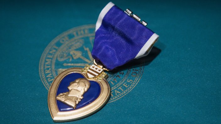 A Purple Heart rests on display before an award ceremony honoring U.S. Army Chief Warrant Officer 2 Corey L. Cook at Fort Carson, Colo., Sept. 15, 2026. Cook received the Purple Heart nearly 16 years after sustaining wounds in an explosion while deployed in Helmand Province, Afghanistan. (U.S. Army photo by Staff Sgt. Luis Solorio)