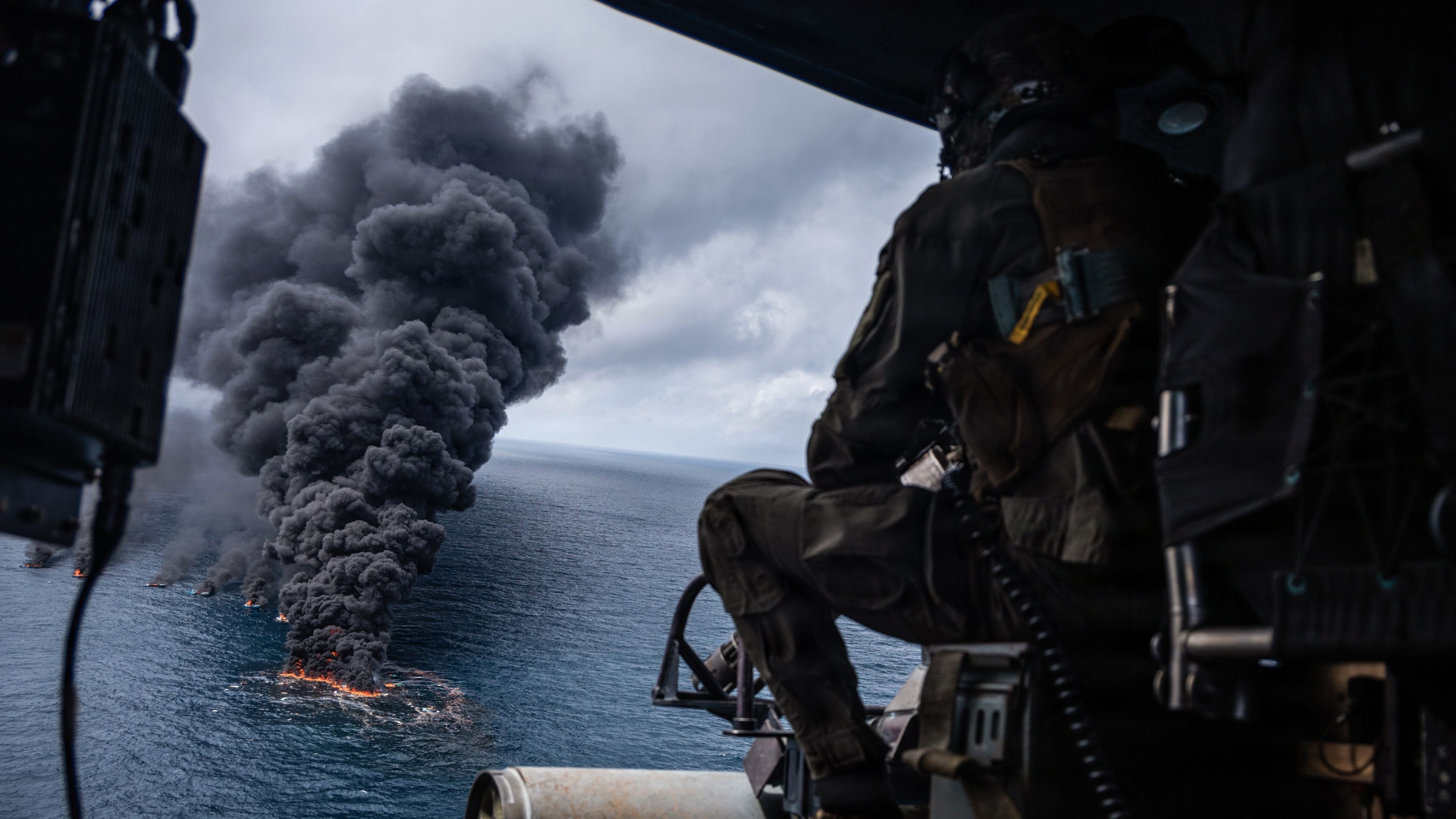 A U.S. Marine UH-1Y Venom helicopter crew chief with Marine Medium Tiltrotor Squadron (VMM) 365 (Reinforced), Littoral Combat Force-24, scans the wreckage of a vessel of interest for floating debris during a Maritime Interdiction Operation while underway in the Pacific Ocean, Sept. 15, 2026. U.S. military forces are deployed to the U.S. Southern Command area of responsibility in support of Joint Task Force Western Hemisphere, Department of War-directed operations, and the President's priorities to disrupt illicit drug trafficking, deter malign actors and protect the homeland through continuous presence. (U.S. Marine Corps photo)