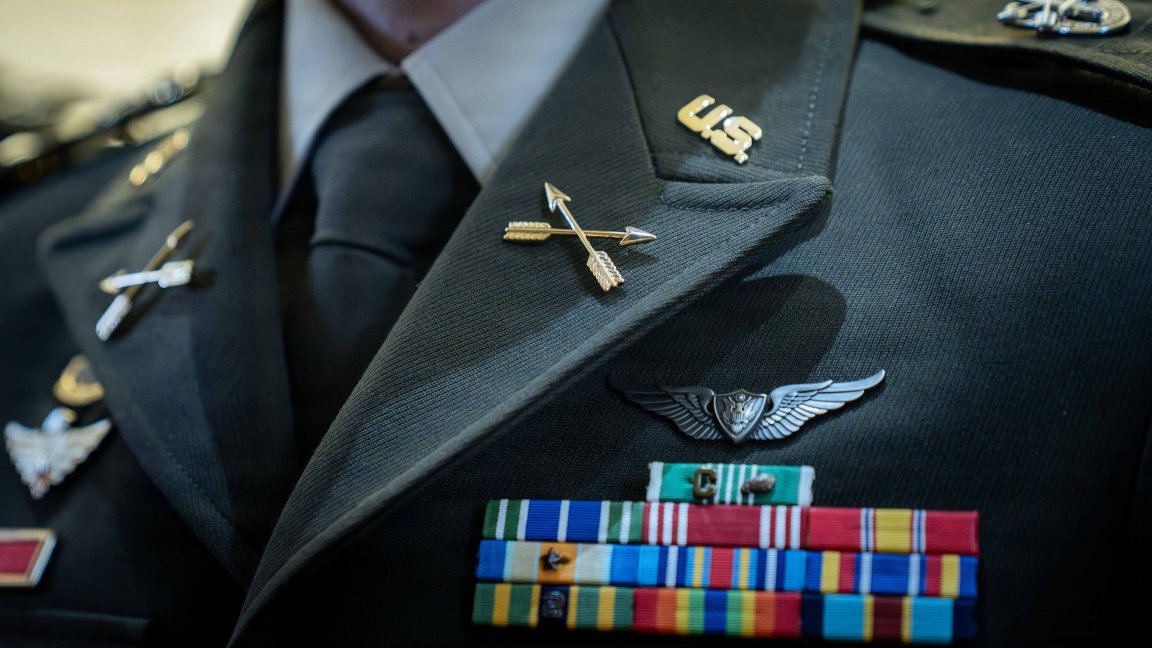 A 390A graduate dons their new Special Forces regimental distinctive insignia following the Activation and Induction ceremony at the U.S. Army John F. Kennedy Special Warfare Center and School, the Special Operations Center of Excellence, at the JFK Auditorium on Fort Bragg, N.C., Oct. 2, 2026. The 10 graduates participated in the historic ceremony as the Army's first 390A warrant officers, embodying the SOCoE’s enduring priority of leader development and professional stewardship by cultivating technically sound leaders prepared to meet the demands of large-scale combat operations. Soldiers in the new 390A Robotics Technician MOS graduated from the Army John F. Kennedy Special Warfare Center and School, the Special Operations Center of Excellence on Oct. 2, 2026. Army photo by Sgt. 1st Class Alexis Washburn.