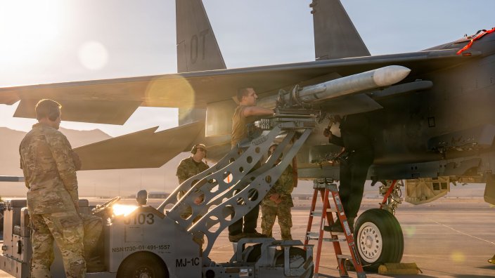 U.S. Airmen assigned to the 757th Aircraft Maintenance Squadron load an inert munition onto an F-15E Strike Eagle aircraft at Nellis Air Force Base, Nevada, Oct. 2, 2026. The Airmen competed in the 3rd Quarter Load Competition in which seven aircraft maintenance teams were assessed on their technical, mental, and physical proficiency. (U.S. Air Force photo by Airman 1st Class Heather Amador Paulino)