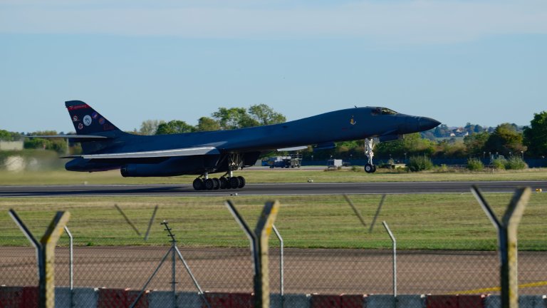 Featured Art: FAIRFORD, ENGLAND - OCTOBER 4: A Rockwell B1 Lancer heavy bomber takes off from runway 27 to depart for home at RAF Fairford on October 04, 2026 in Fairford, United Kingdom. Around a dozen US B-1B Lancer bombers remain stationed at RAF Fairford in Gloucestershire, following a significant military drawdown late last month that saw six B-52 Stratofortress bombers return across the Atlantic. The heavy aircraft are part of an American forward strike force that has used the Gloucestershire airfield to conduct missions against Iranian capabilities, with total aircraft numbers at the Gloucestershire hub previously peaking between 21 and 23 strategic bombers earlier this year. (Photo by David Bown/Getty Images) 