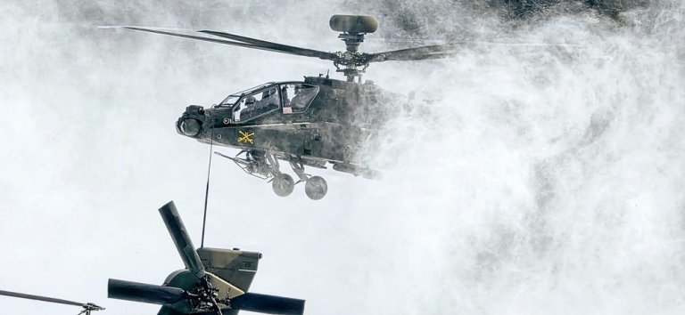 U.S. Army Chief Warrant Officer 2 Mitch Flowers and Chief Warrant Officer 2 Dustin Pettis, assigned to Alpha Company, 1-3 Attack Battalion, 3rd Combat Aviation Brigade, land their AH64E Apache on Sierra Checkpoint at Joint Multinational Readiness Center's Hohenfels Training Area, Germany, Feb. 18, 2026, to rearm and refuel. 7th Army Training Command provides a unique environment in Europe to develop leaders and formations who are prepared for large-scale combat operations.